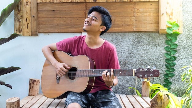 A man playing guitar in park