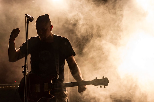 man playing guitar on stage