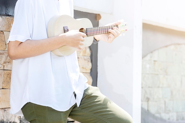 Man playing guitar ukulele