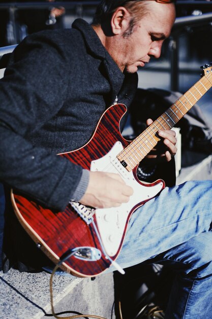 A man playing a guitar with a guitar