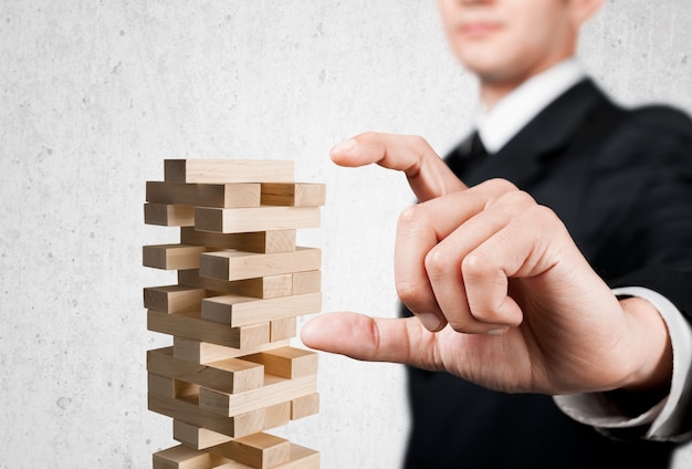 Man playing jenga game, game of physical skill