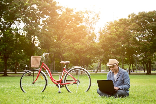 Man playing laptop computer At the park