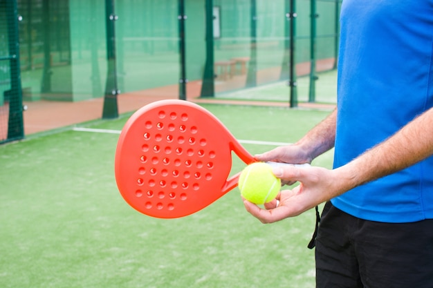 man playing paddle tennis