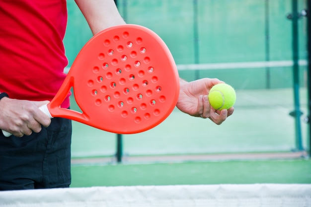 man playing paddle tennis