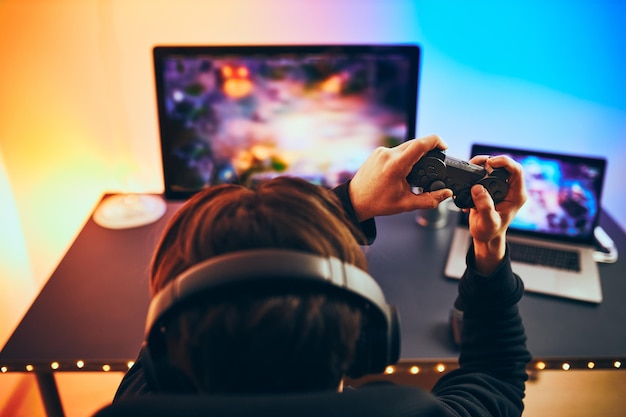 Man playing video game gamer playing championship tournament competition and having fun gaming