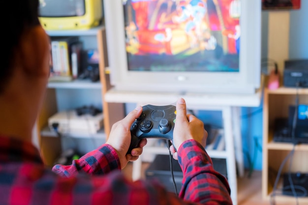 Photo man playing video game while sitting at home