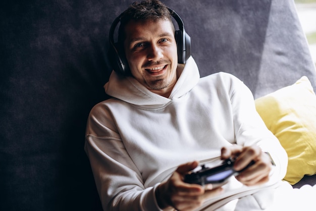 Photo man playing video games using joystick