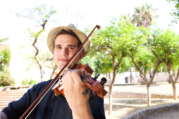 Man playing violin outside