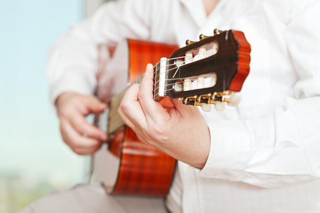 Photo man plays on classical acoustic guitar