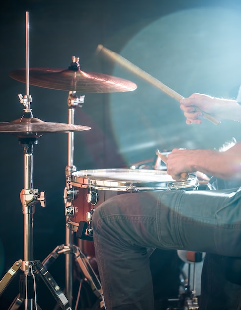 man plays the drum, flash of light