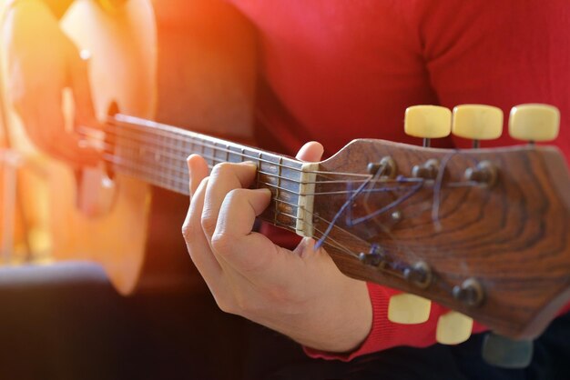 Foto un uomo suona la chitarra da vicino il musicista suona la chitara lo sfondo musicale il concetto musicale