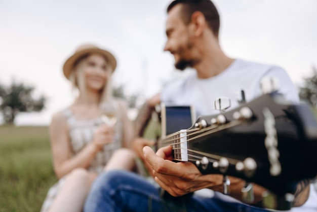 a man plays the guitar for his girlfriend