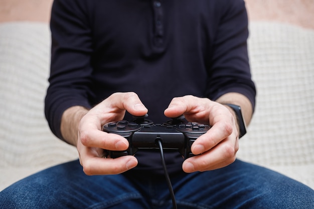 A man plays video games with a joystick in his hands