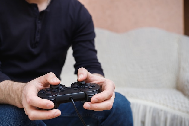 a man plays video games with a joystick in his hands