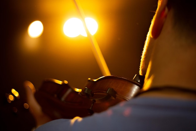 A man plays the violin on the stage of close