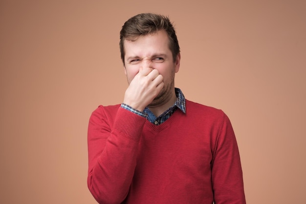 Man plugs nose as smells something stink