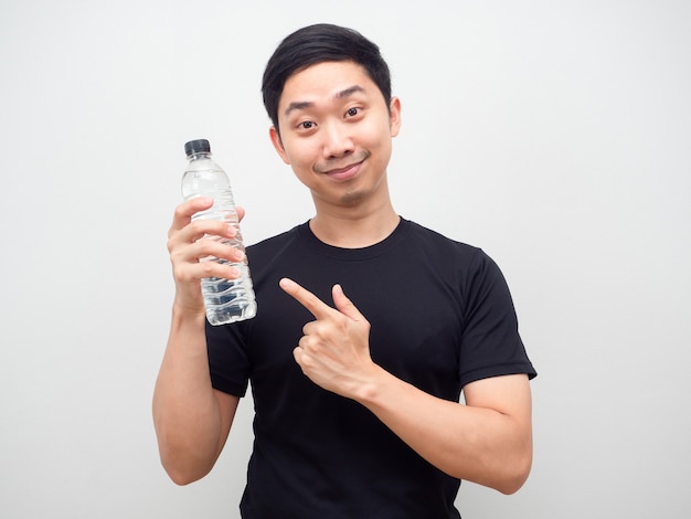 Man point finger at water bottle in his hand with happy face white background