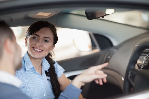 Man pointing a car interior