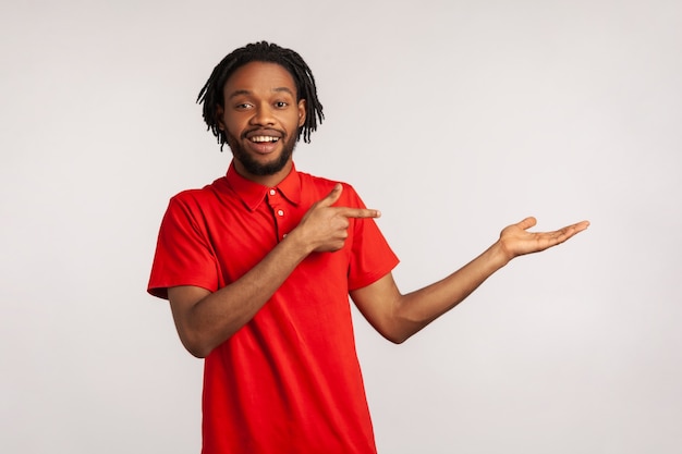 man pointing at copy space on his palm showing empty place for idea presentation