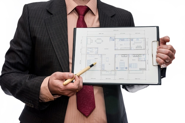 Man pointing on house plan isolated on white wall