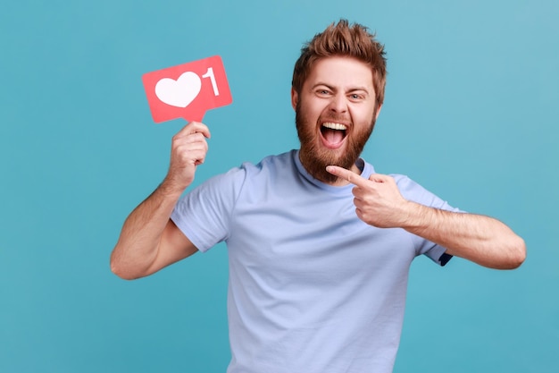 Man pointing at red like counter sign asking for more reactions on his content in social media