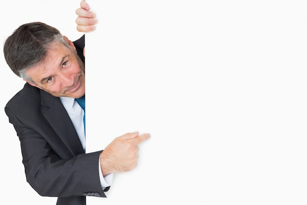 Photo man pointing to whiteboard and smiling