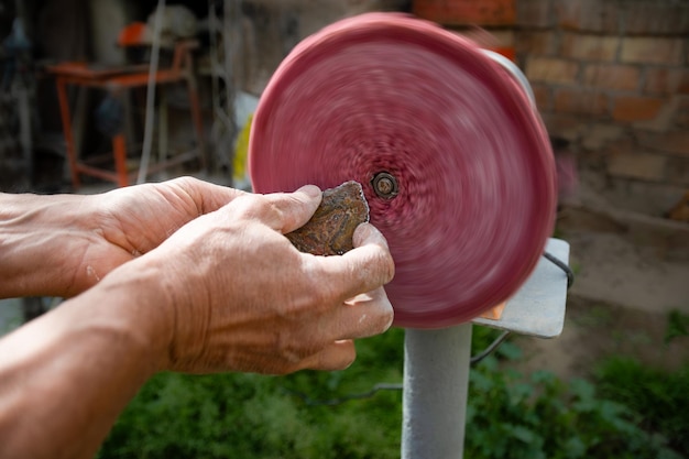 Man polishing agate stone with a lathe