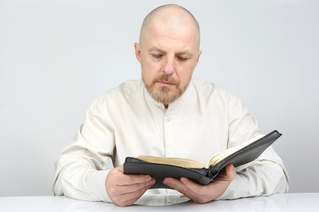 남자가 성서 책을 읽고 숙고하다