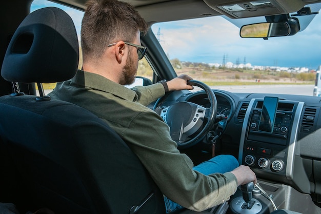 Man portrait in car road trip travel concept