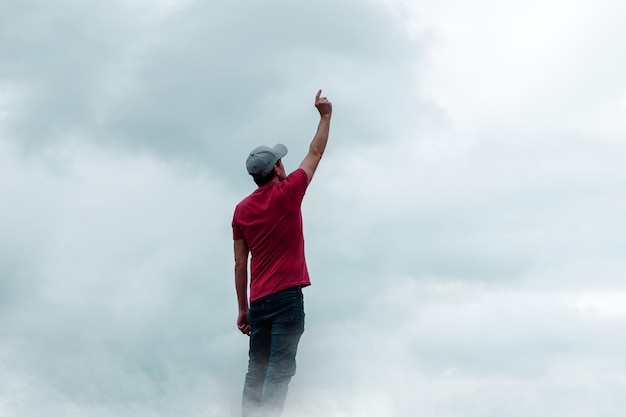 man portrait gesturing in the sky and clouds