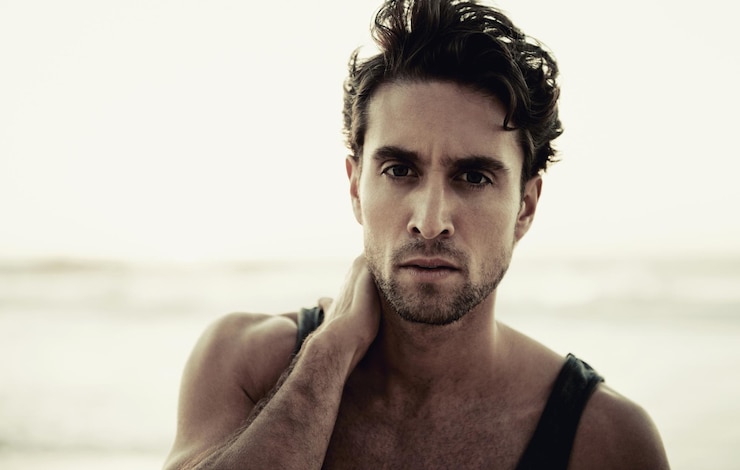 Photo man portrait and travel to beach on vacation confidence and relaxing at sea on summer holiday male person serious face and tourism in netherlands calming ocean and peaceful environment in nature
