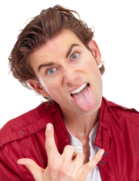 Photo man in portrait with tongue out rock hand gesture and facial expression isolated on white background punk rocker and emoji with crazy face in studio male model with energy and devil horn symbol