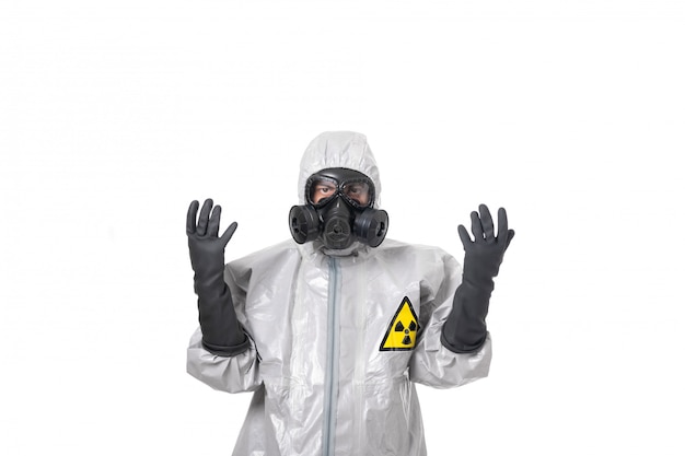 A man poses in a gray protective suit