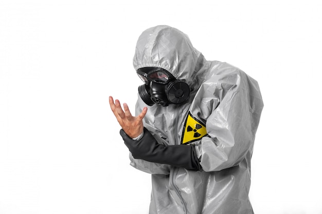 A man poses in a gray protective suit