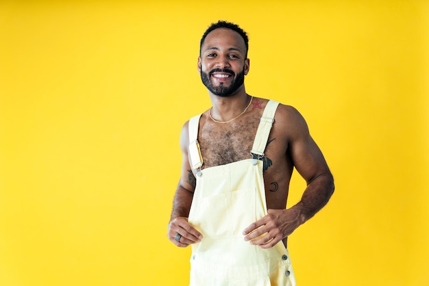 Man posing on colored backgrounds in studio wearing trendy clothes