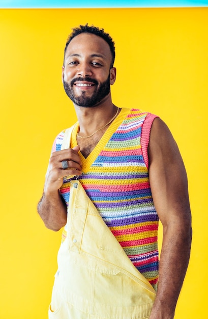 Man posing on colored backgrounds in studio wearing trendy clothes