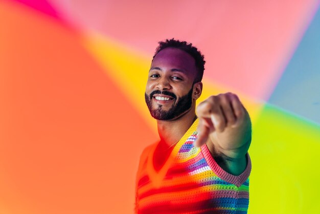 Man posing on colored backgrounds in studio wearing trendy clothes