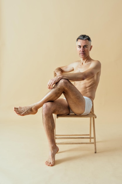 Photo man posing for a male edition body positive beauty set. shirtless guy wearing boxers underwear in studio