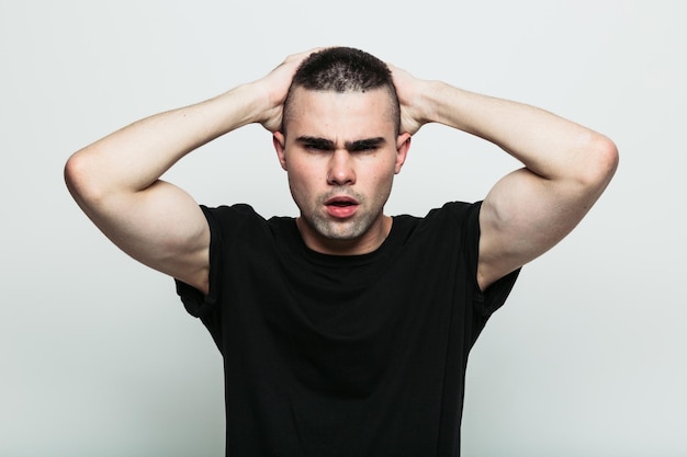 Man posing with arms on head