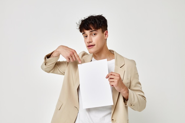 Man posing with a white sheet of paper light background unaltered