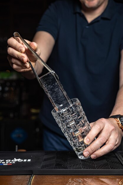 A man pouring a glass into a bar