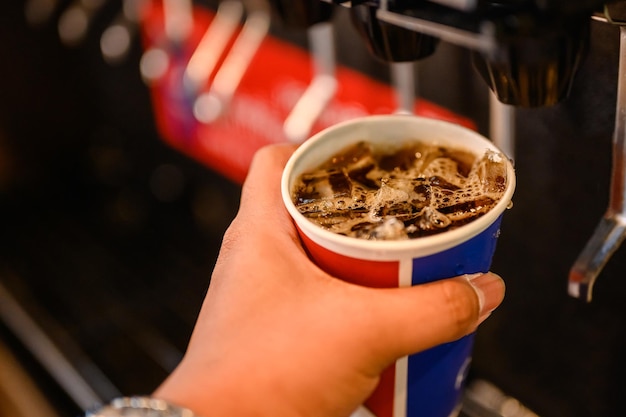 Man pours a fizzy drink.sparkling water.cool ice soft drink cola