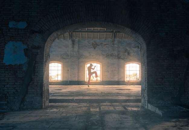 Man practicing martial arts in abandoned building