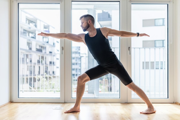 Man practicing yoga at his home