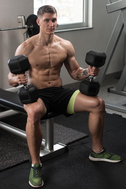 Man Preparing To Doing Shoulders Exercise With Dumbbells