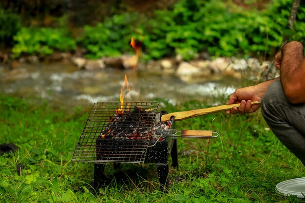 Man preparing food on barbecue grill