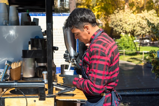 Man preparing hot coffee on a sunny afternoon coffee bike food
concept