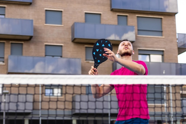 Man preparing to spike the ball in Pickleball In Pickleball it is prohibited to volley hit the ball without first touching the ground with any foot inside the zone or touching the Novolley line