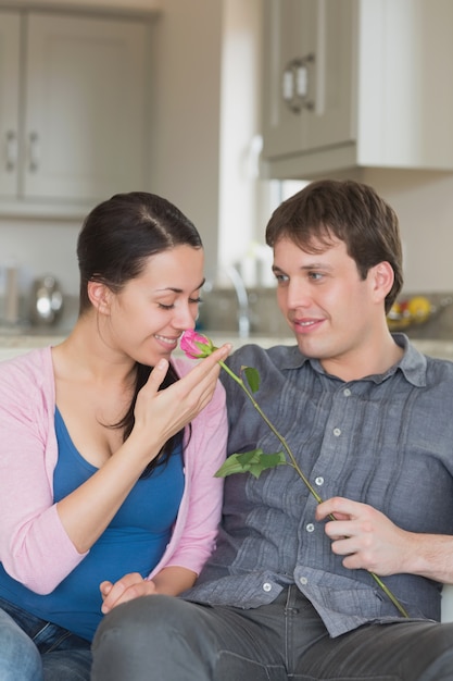 Man presenting flower to wife