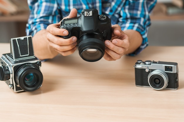 Man presenting modern digital camera